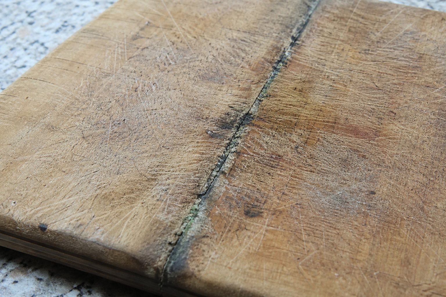 Mould in the crack of a wooden cutting board